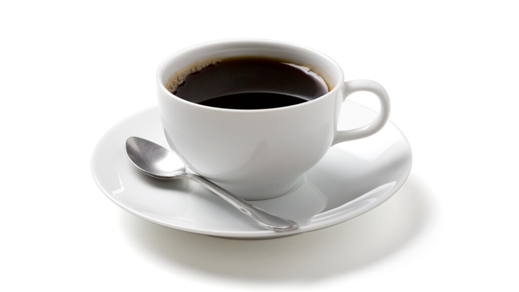 Black coffee in cup saucer and spoon