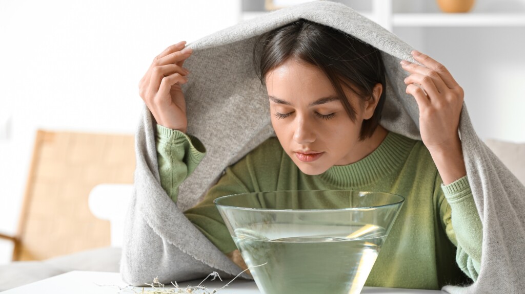 Girl taking steam inhalation.