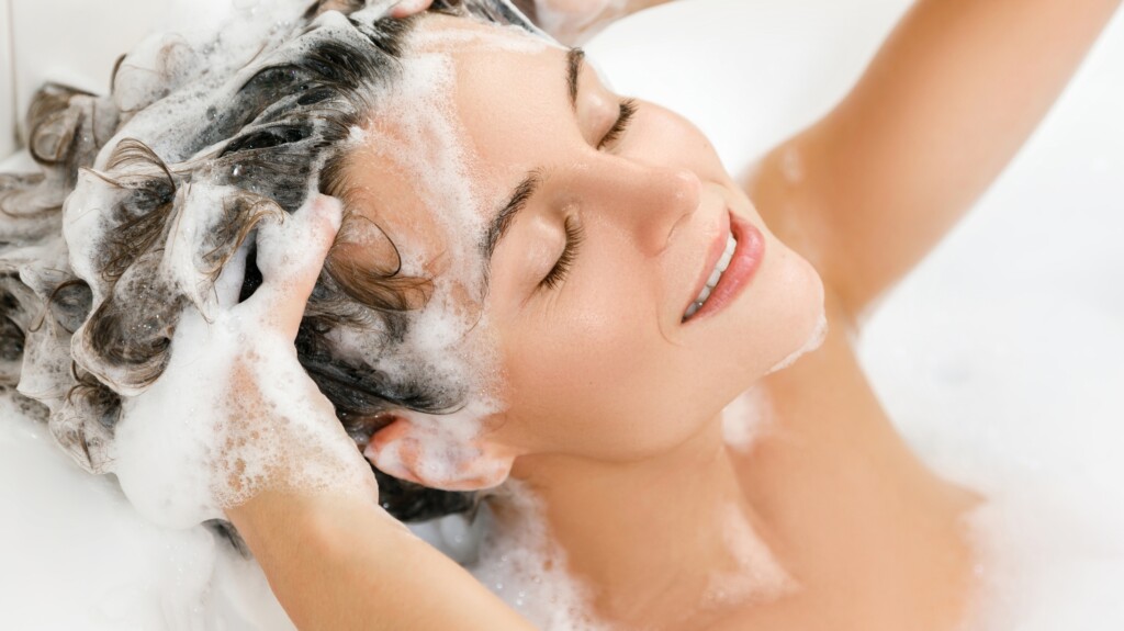 Woman Is Washing Her Hair with Shampoo.