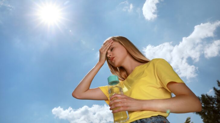 Woman with Bottle of Water under sun.