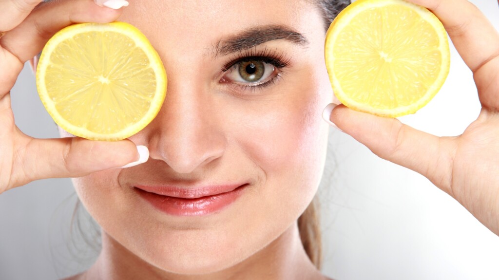 Beautiful Woman Holding Juicy Lemons