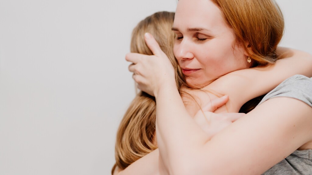 mother hugs daughter