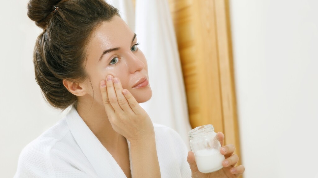 Woman Applying Coconut Oil.